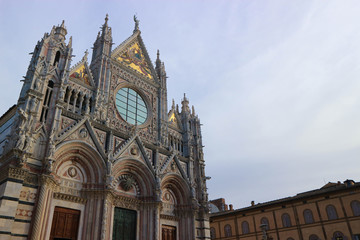 View to facade of Cathedral of Saint Mary of the Assumption in winter morning with clear sky, Siena, Tuscany, Italy