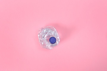 deformed plastic bottle on pink background
