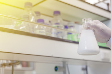 hand with white glove holding Concentrated latex