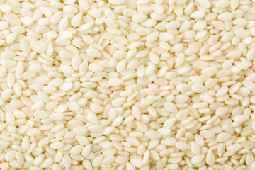 White peeled sesame seeds close up, background, texture