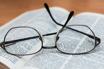 Closeup of Reading Glasses on Book