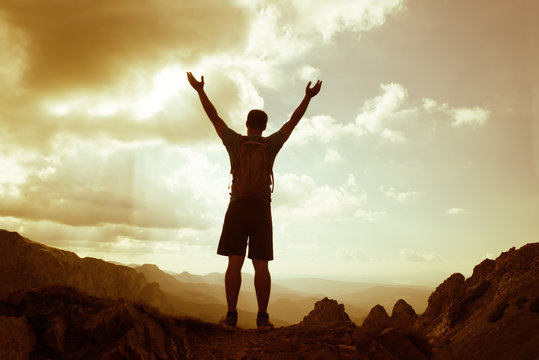 silhouette of successful man on the top of mountain. Concept of sport motivation inspiration