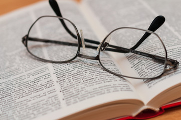 Closeup of Reading Glasses on Book