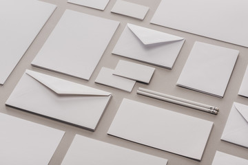 Flat lay with white pencils, envelopes, empty cards and sheets of paper
