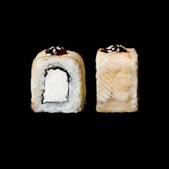Sushi. Canada roll with eel and cream cheese, isolated in black background