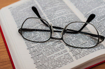 Closeup of Reading Glasses on Book