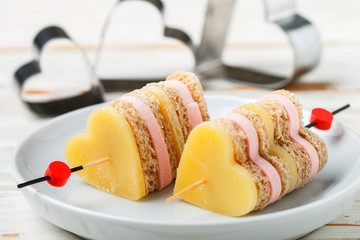 Mini sandwiches parmesan cheese ham bread on skewers in the form of hearts. Valentine's day....