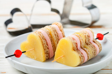 Mini sandwiches parmesan cheese ham bread on skewers in the form of hearts. Valentine's day. Breakfast for loved ones. Selective focus and copy space