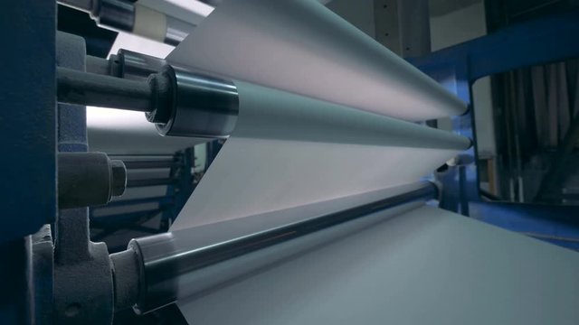 Printing machine and white paper rolling through it