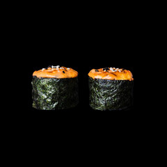 Sushi. Baked rolls with salmon, isolated in black background