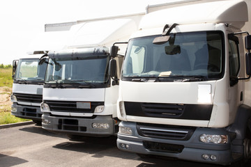 three face truck white for delivery front of warehouse