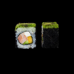 Sushi. Roll with smoked chicken, avocado, mango, cream cheese, kiwi, black tobiko, isolated in black background