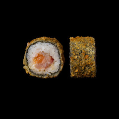 Sushi. Roll with salmon tempura and cream cheese, isolated in black background