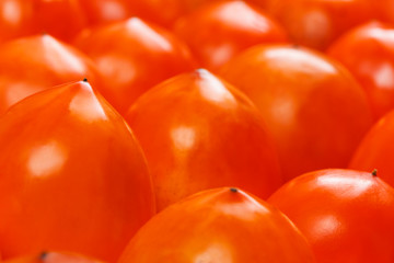 Fresh ripe persimmons in market. Persimmons background.