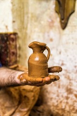 pottery, workshop, ceramics art concept - male master works with hands and potter wheel . 