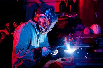 Welding metal in shop