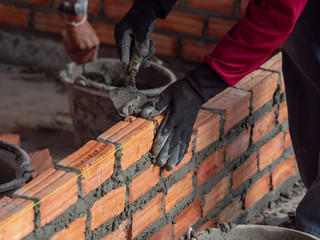 Building brick block wall on construction