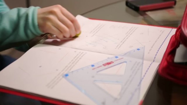 Young girl doing geometry at home.
