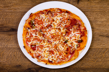 Pizza with sausages and tomato