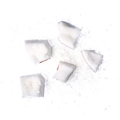 Coconut slice piece shavings on white background isolation, top view