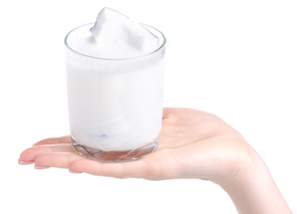 A glass of coconut milk in hand on a white background. Isolation