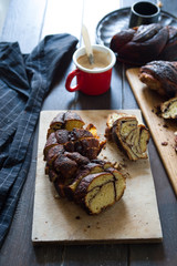Babka jewish baked is ready to be eaten, over a wooden background, easter concept.