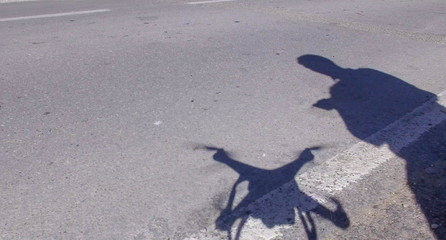 Man and drone silhouettes on the ground
