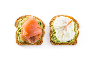 Toasted breads with avocado, poached eggs and salmon isolated on white background. Top view.