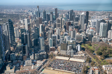 Naklejka na ściany i meble MELBOURNE - SEPTEMBER 8, 2018: Aerial view of city skyline and car parking from helicopter. Melbourne attracts 15 million people annually