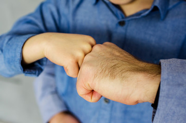  Father's hands with son