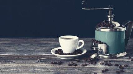 Coffee mill and cup of espresso. Concept of coffee drinking tradition. Selective focus. Wooden...