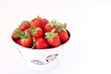 strawberries in a bowl isolated on white