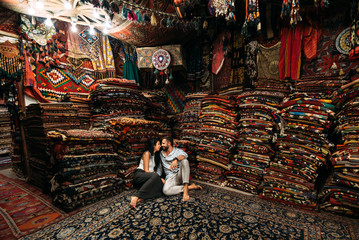 Couple having fun. Couple in love in Turkey. Man and woman in the Eastern country. Gift shop. A...