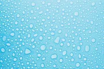 closeup drops water on blue background