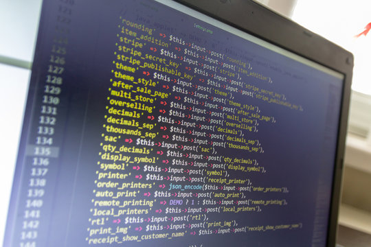 Modern software development background: nice looking laptop with programm on display.