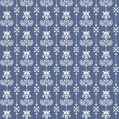 Seamless floral pattern in vector. Small white flowers and paisley on a blue background.