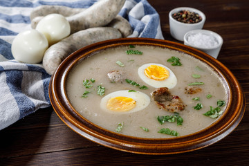 Sour rye soup on wooden table
