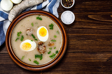 Sour rye soup on wooden table