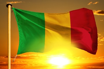 Mali flag weaving on the beautiful orange sunset with clouds background