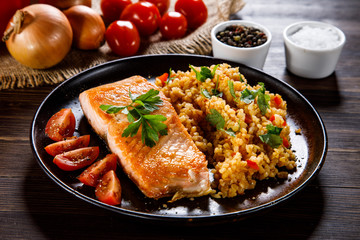 Roast salmon with groats and vegetables