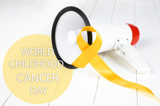 Yellow ribbon symbolic color for Sarcoma Bone cancer awareness and suicide prevention on aged wood with megaphone. The cancer, health, help, care, support, hope, illness, healthcare concept