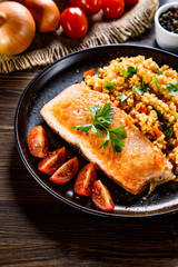 Roast salmon with groats and vegetables