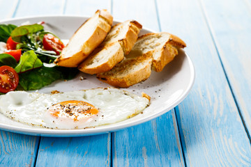 Breakfast - fried egg ,toasts and vegetabla salad