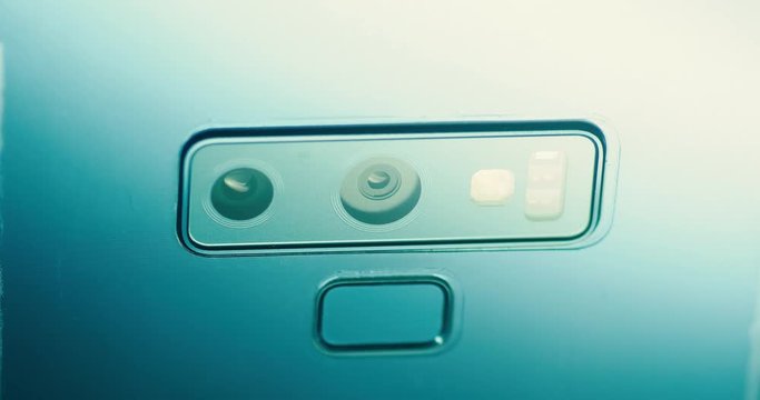 Close view of a smartphone lens taking pictures.