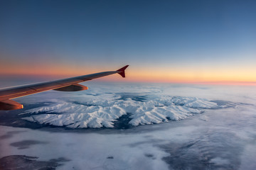 Flying over the Arctic mountains. Airplane overflying the Khibiny Mountains in Russia's Kola...