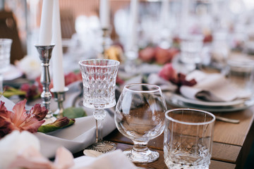 Elegant Wedding table set with pink wlowers and candlesticks 