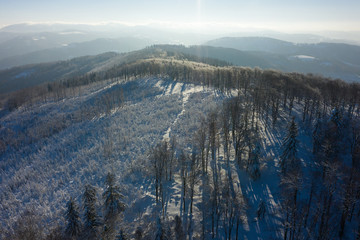 Winter scenery in Silesian Beskids mountains. View from Rownica, Ustron. View from above. Landscape photo captured with drone. Poland, Europe.