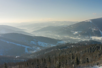 Obraz premium Winter scenery in Silesian Beskids mountains. View from Rownica, Ustron. View from above. Landscape photo captured with drone. Poland, Europe.