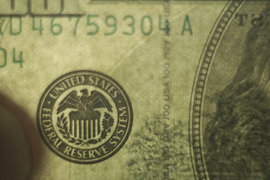  macro photo of federal reserve system symbol on hundred dollar bill    