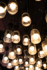 decorative light bulbs in glass jars on the ceiling